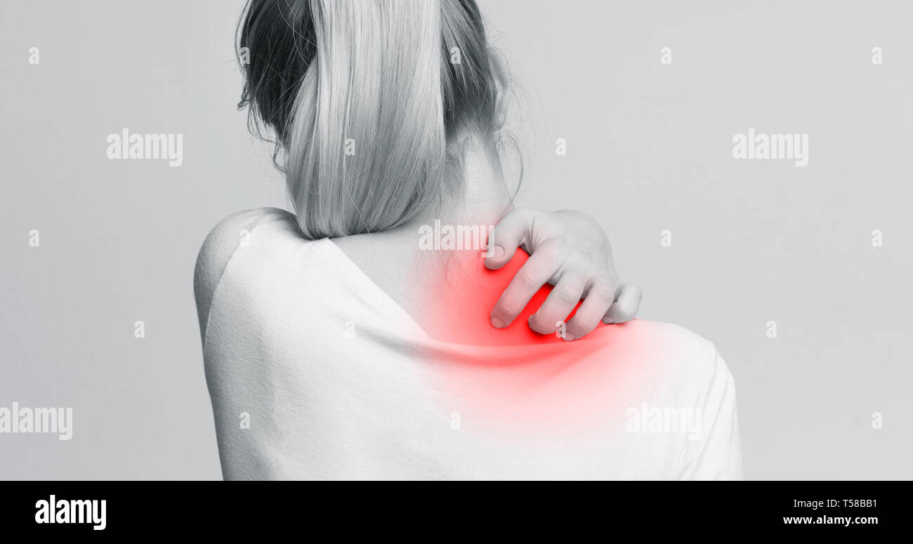 Woman with symptoms of itchy urticaria, scratching her neck Stock Photo