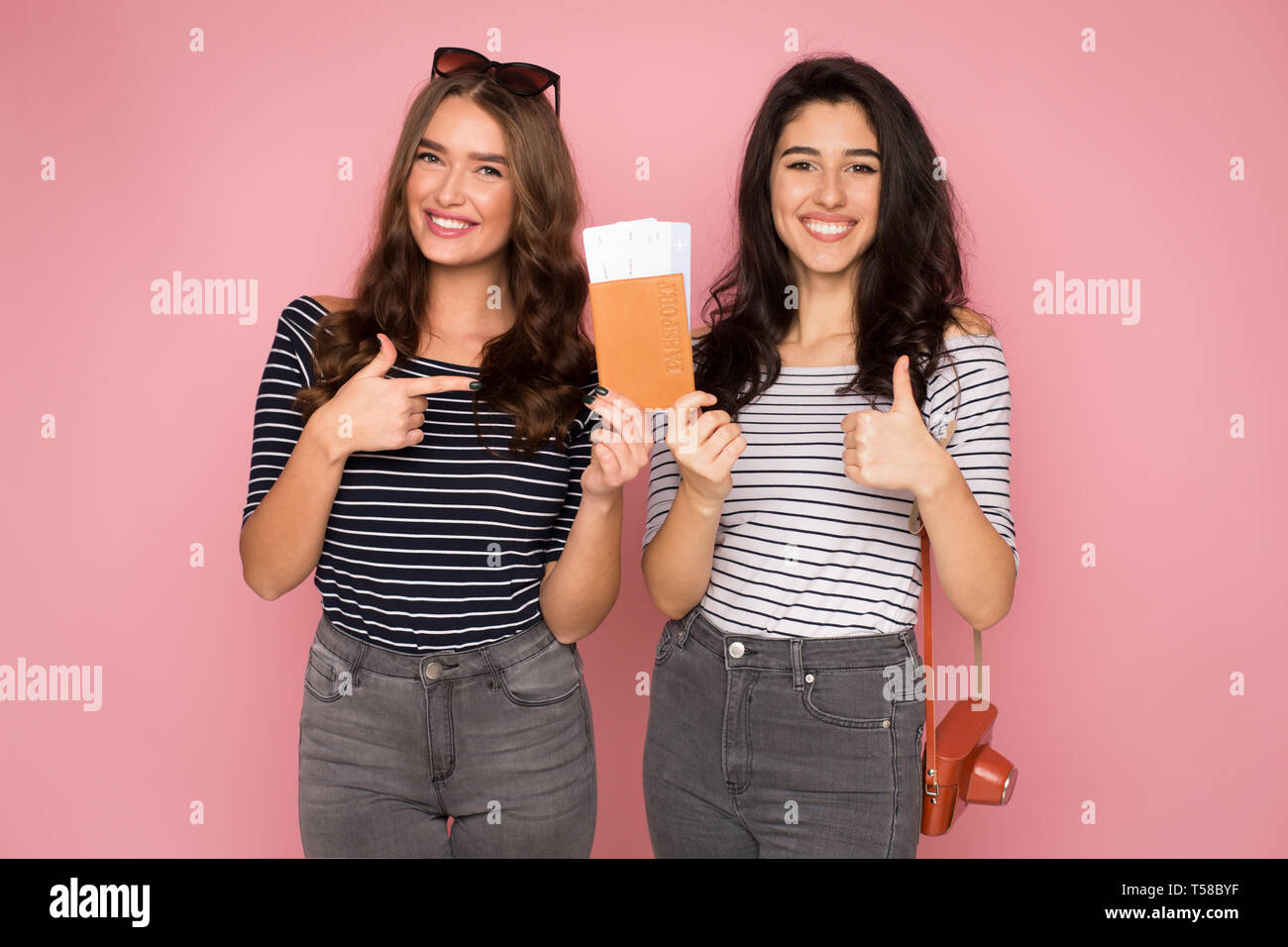 Best friends goint to trip, holding tickets and passport Stock Photo