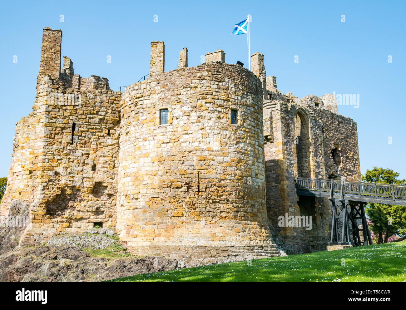 Medieval 13th century Dirleton Castle fortress with moat, popular visitor attraction, East Lothian, Scotland, UK with blue sky Stock Photo