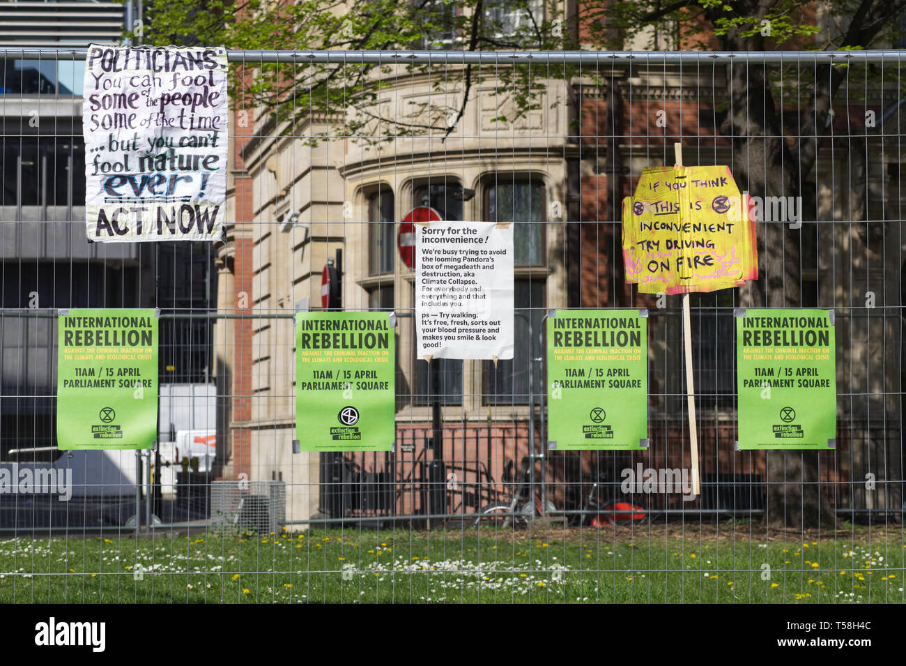 Posters attached to fencing for the Extinction rebellion Parliament square London Stock Photo