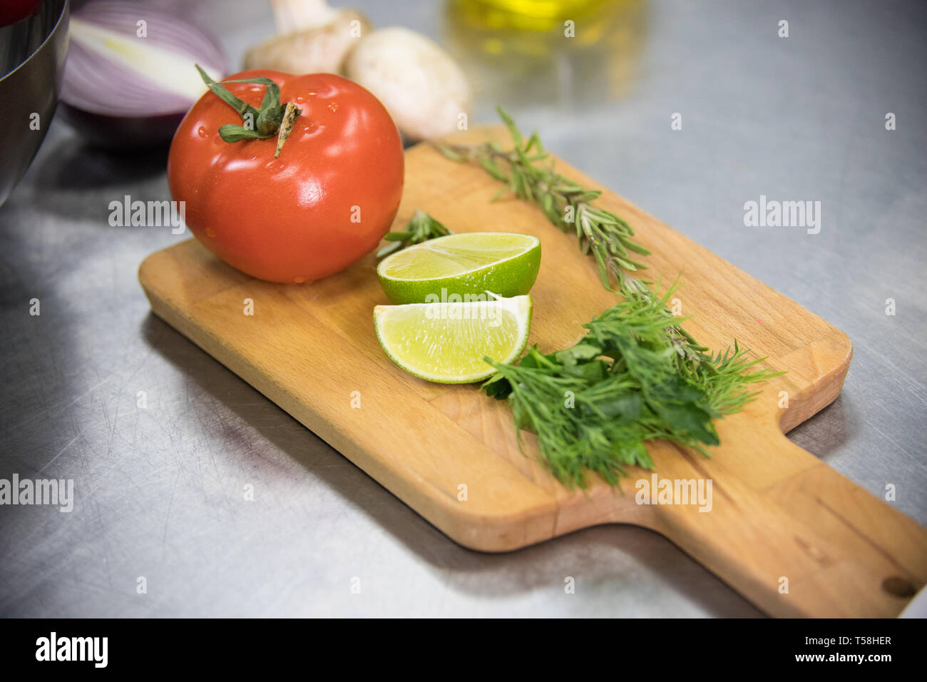 Restaurant Kitchen A Tomato And Lime On The Desk Stock Photo