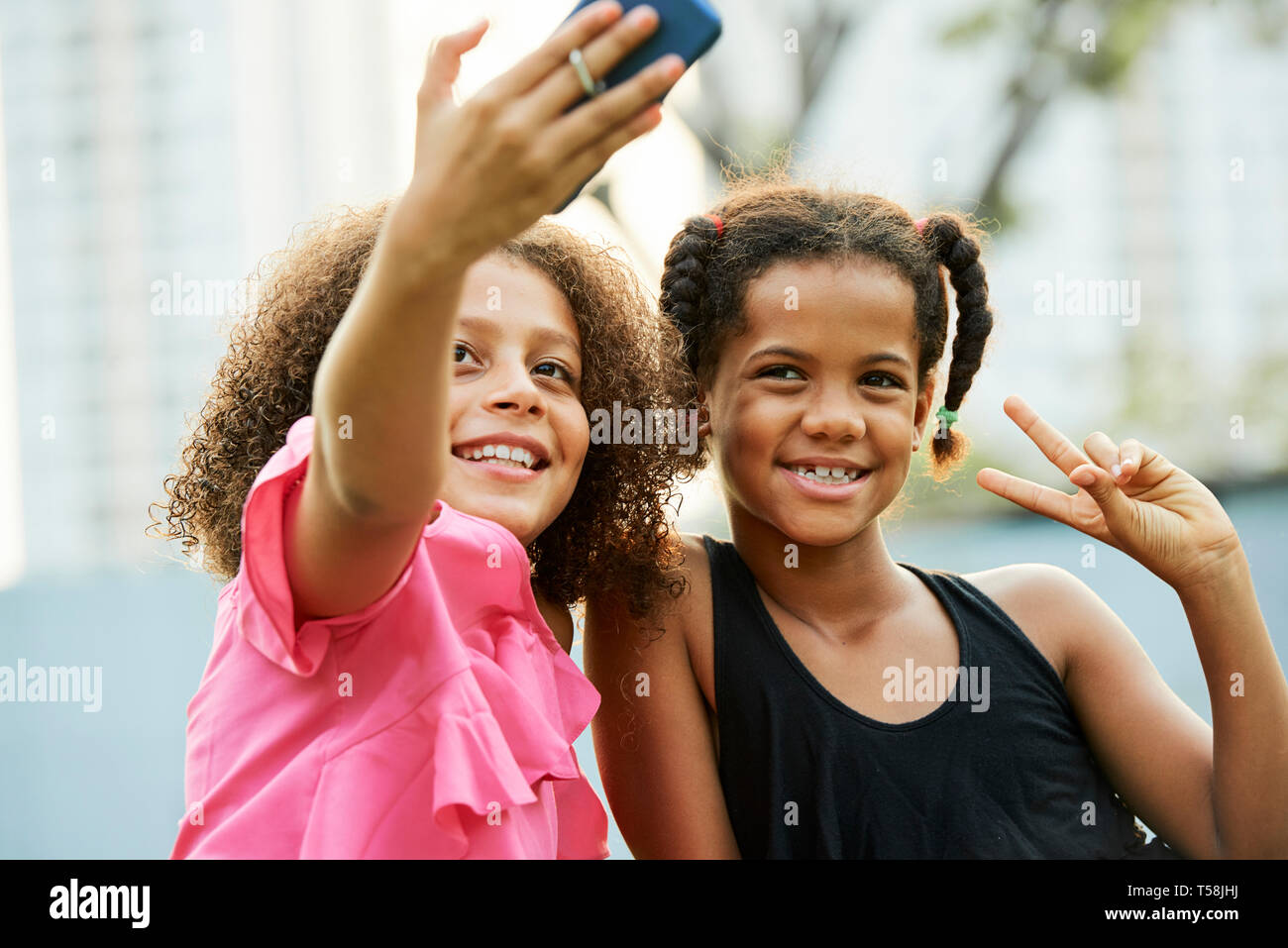 Cool girls taking selfie outdoors Stock Photo
