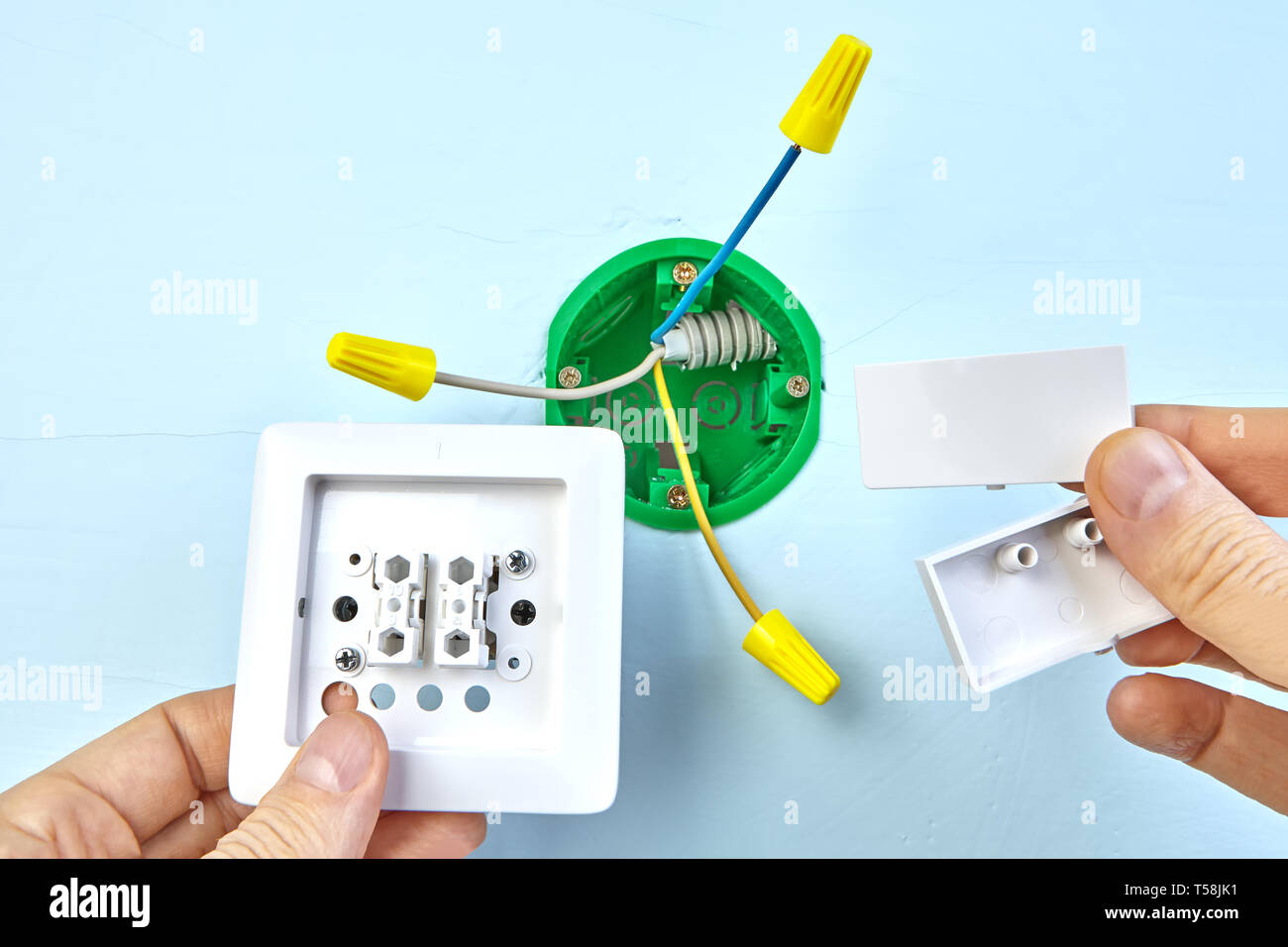Worker is mounting european two-button switch, electrical installation ...