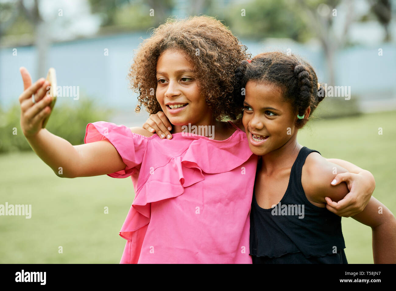 Cheerful African girls photographing together Stock Photo
