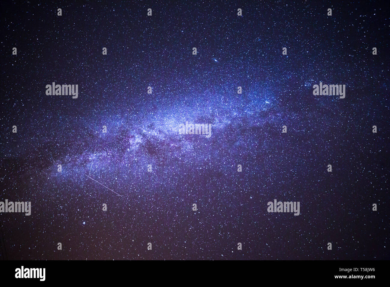 Shooting Stars Crossing in Milky Way and Starry Sky before Dawn Stock Photo