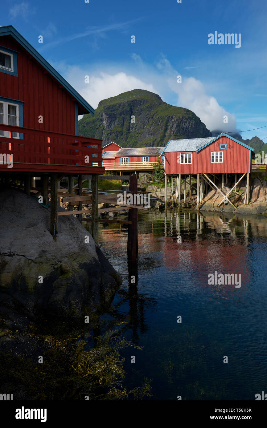 The red Rorbu Norwegian traditional fisherman houses built on wooden stilts in the fishing village of Å on Moskenesøya in the Lofoten islands Norway Stock Photo