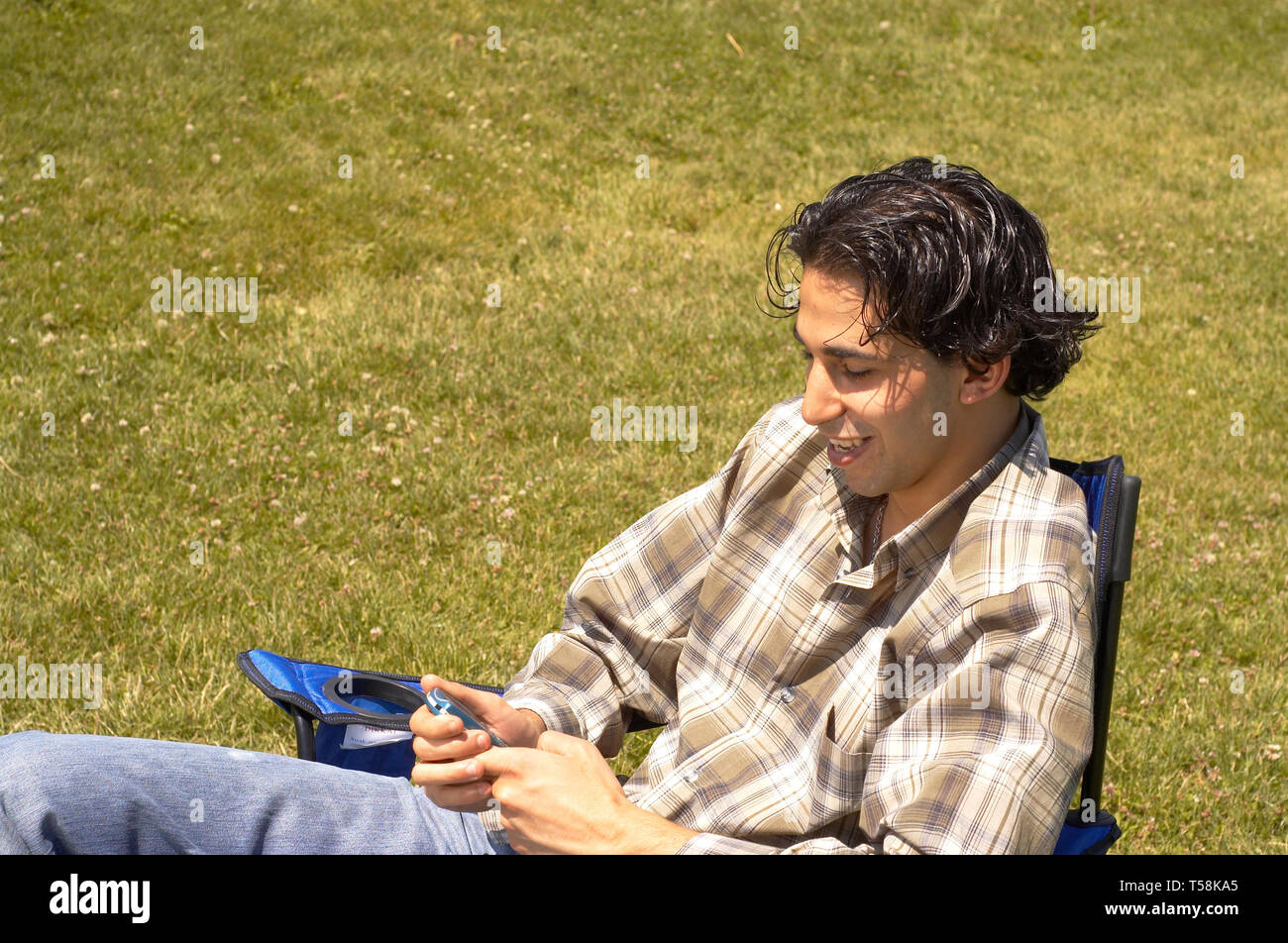 Boy Send Msg casual boy sending message with his mobile phone Stock Photo - Alamy