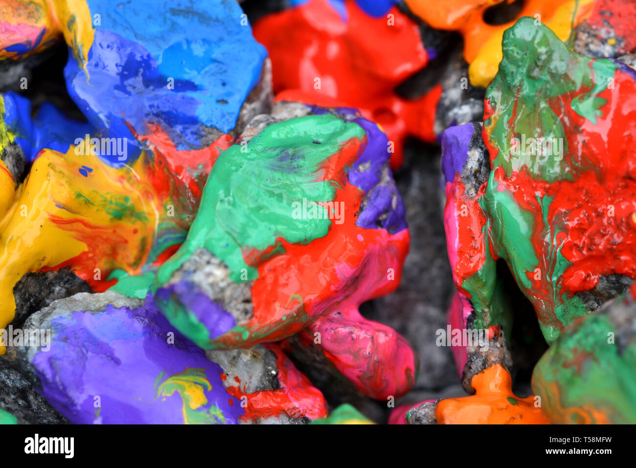 stones with colorful paint. Abstract background colored stones randomly in different colors Stock Photo