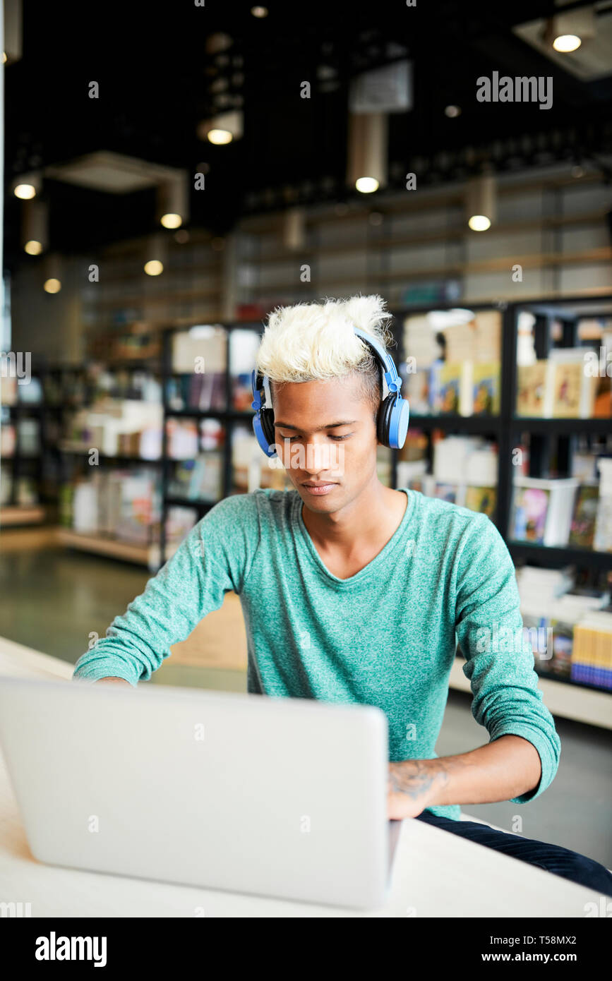 Serious university student using laptop Stock Photo