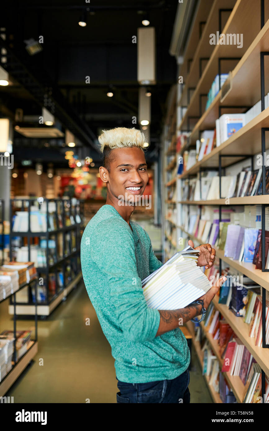 Happy bookstore employee in shop Stock Photo Alamy