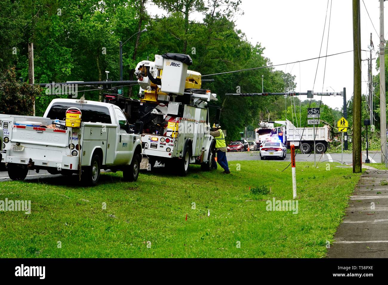 Aftermath of storm, wind, damage with police and utility crews cleaning up downed power lines and trees in Gainesville, Florida, USA. Stock Photo