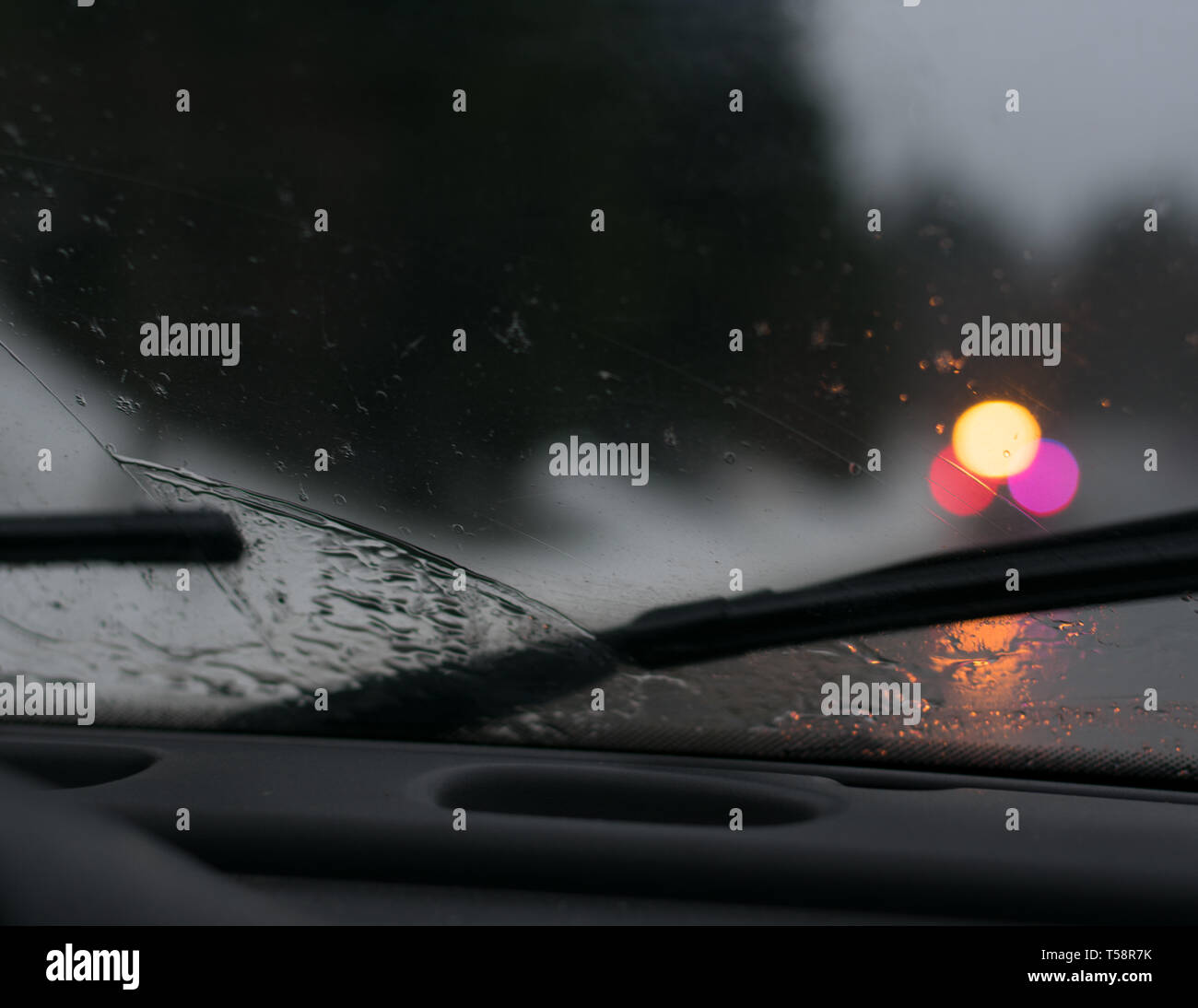 Stormy drive in car with wet windshield wipers on dashboard Stock Photo