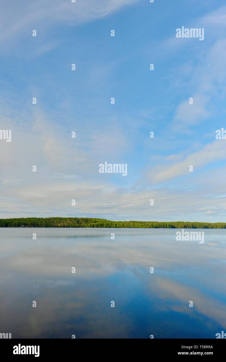 The still water and blue sky summer lake landscape of Sweden. Stock Photo