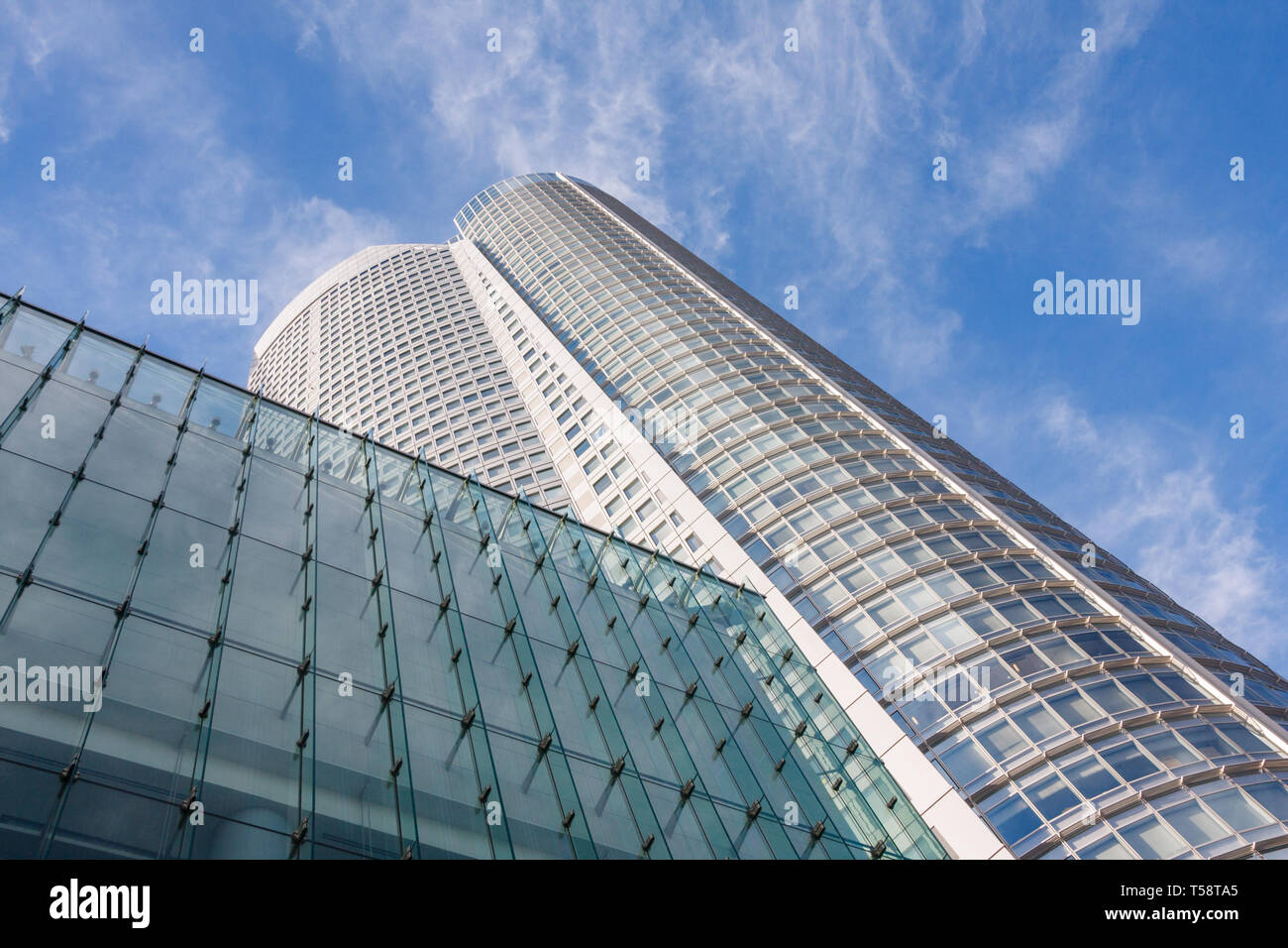 Facade of Roppongi Hills Mori Tower under a blue sky with clouds. With 238m. it is Tokyos 6th highest building. Toky, Japan. Stock Photo