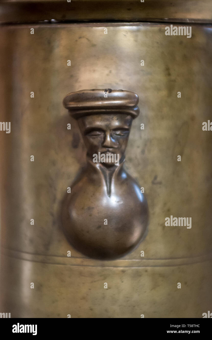 A small bronze man's head looks out from the column of the 600 year old, 3.7m  tall, seven-branched candlestick in Storkyrkan (Stockholm Cathedral). Stock Photo