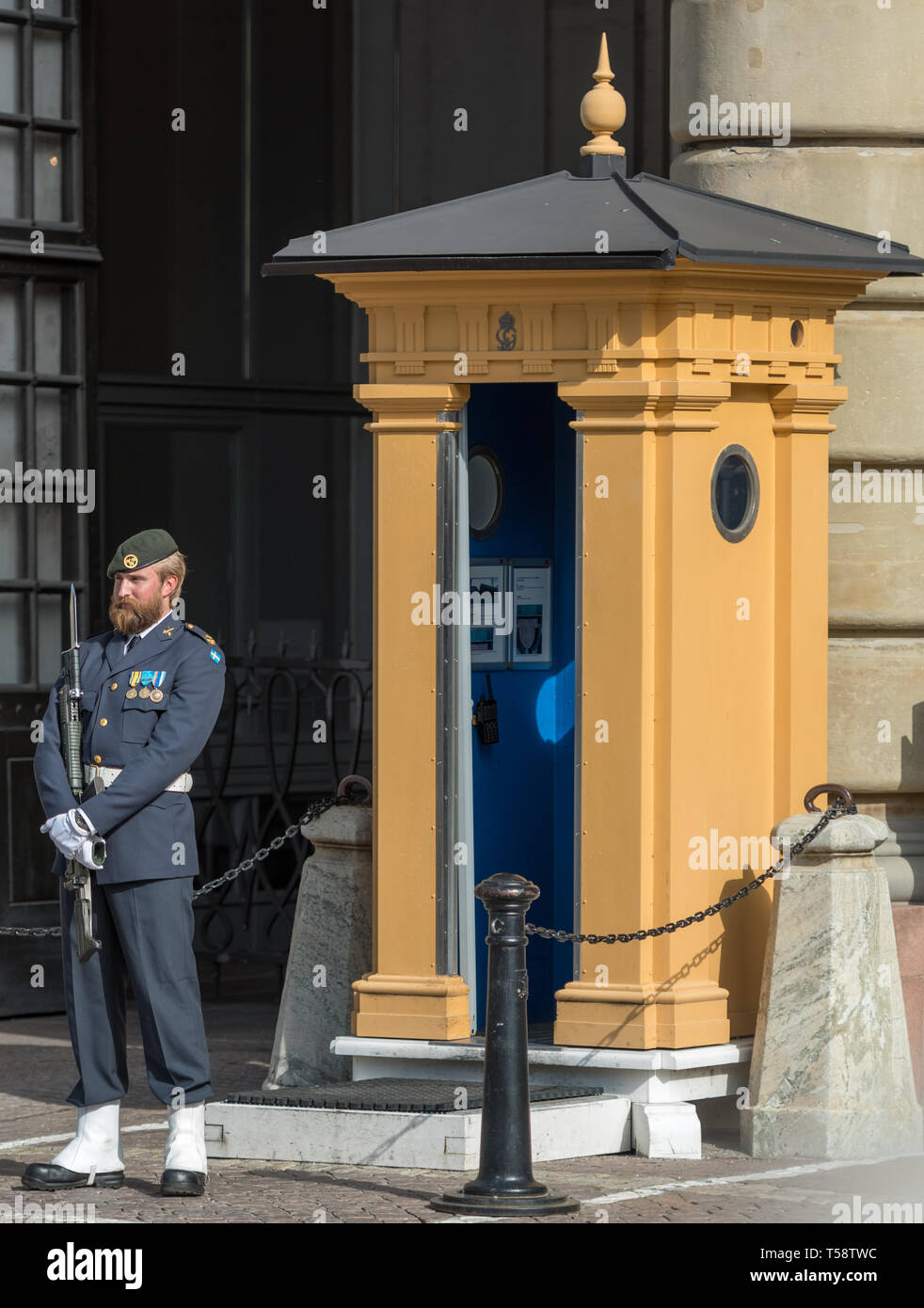 A bearded sentry stands on guard by his ornate sentry box at Stockholm Royal Palace following the changing of the guard Stock Photo