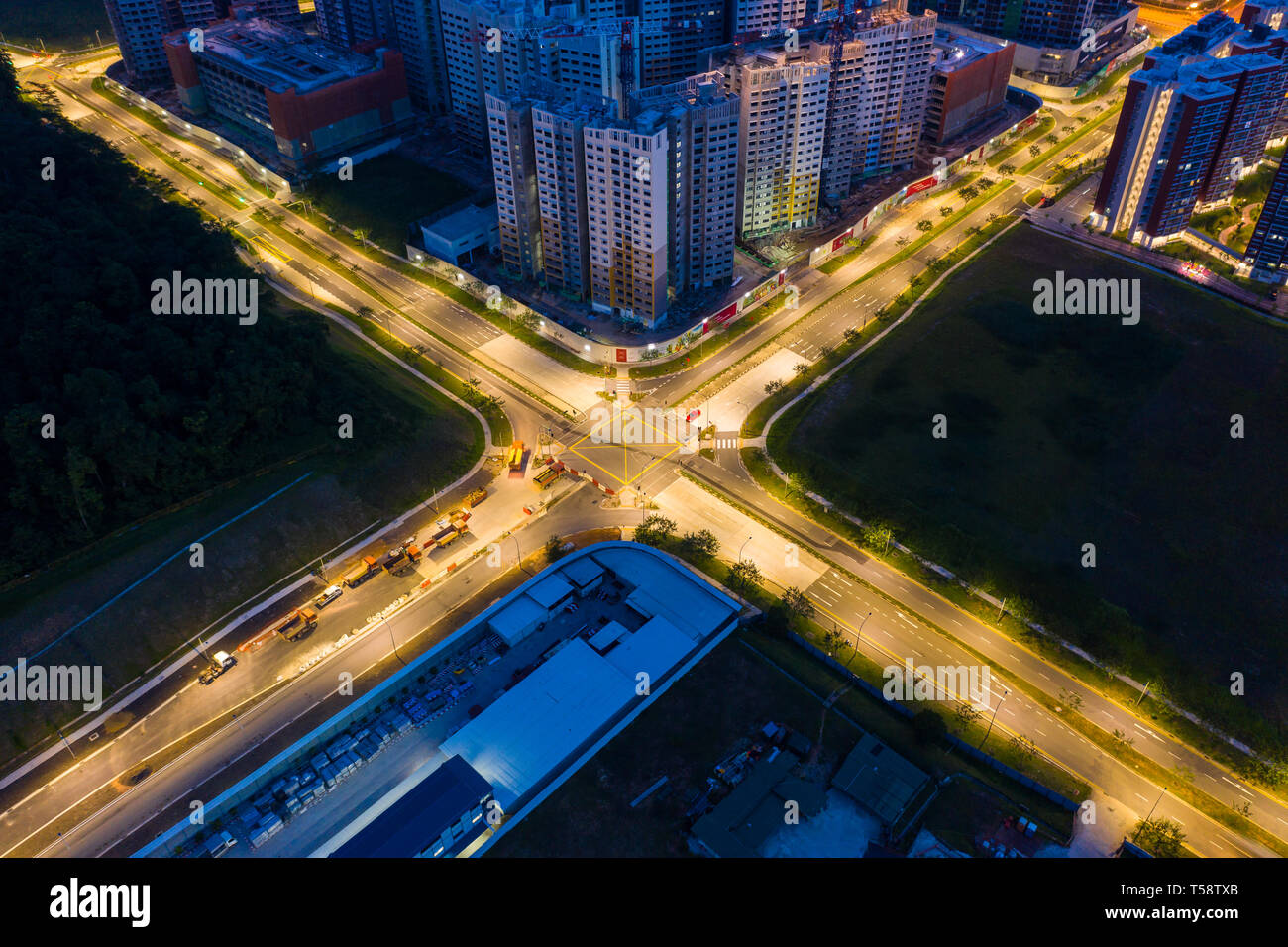 Aerial view of lighted roads cross junction with no traffic in the night Stock Photo