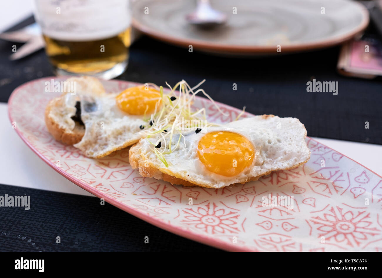 plate of fried eggs on crispy toast with truffle Stock Photo Alamy