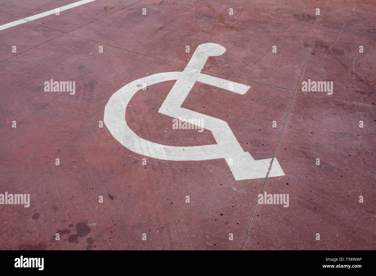 disabled white sign painted on a red floor Stock Photo