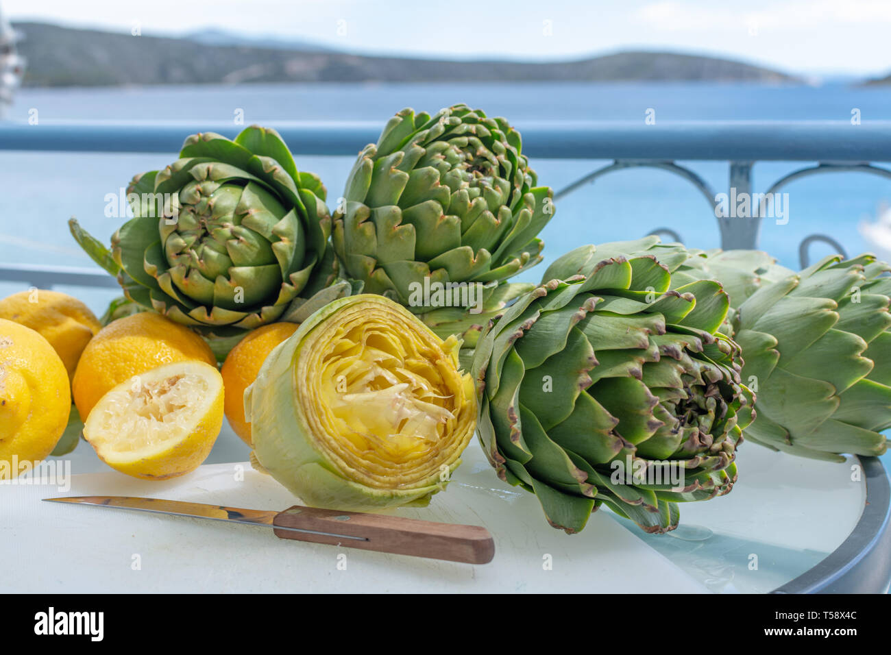 Preparation of heads of fresh raw green artichokes plants from