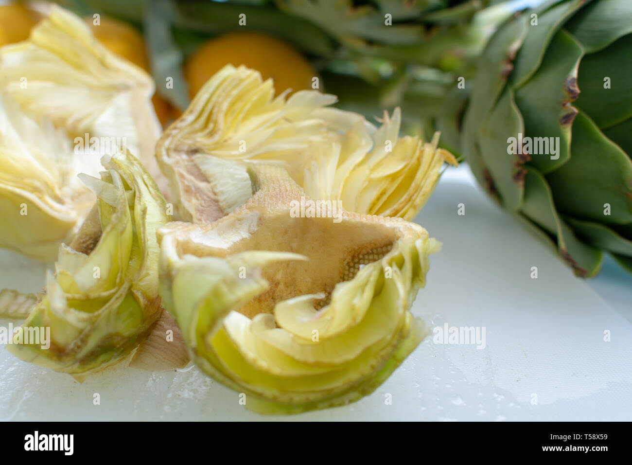 Preparation of heads of fresh raw green artichokes plants from