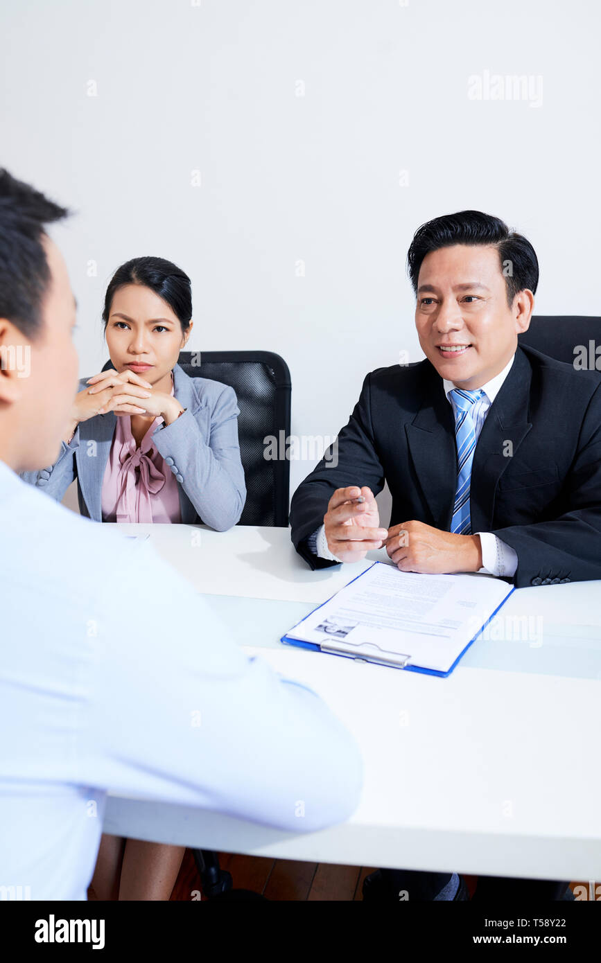 Employer talking to colleagues Stock Photo