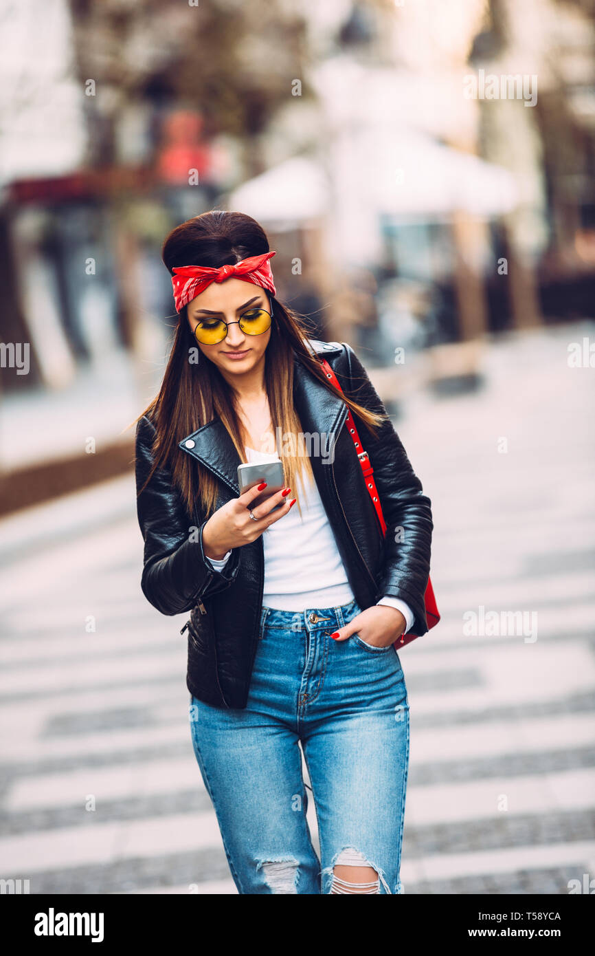 Portrait Of Young Beautiful Trendy Girl In Stylish Sunglasses Using Smart Phone Stock Photo Alamy