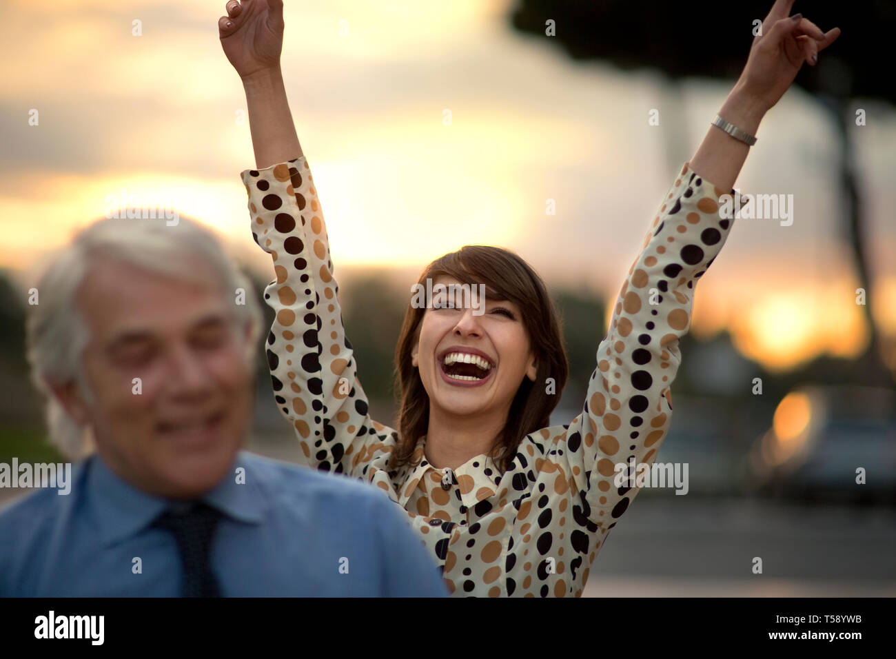 Smiling young business woman celebrates her success. Stock Photo