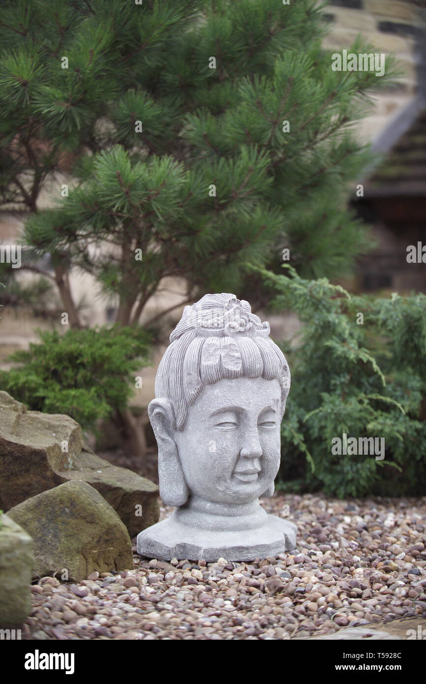Buddha head in Japanese garden Stock Photo