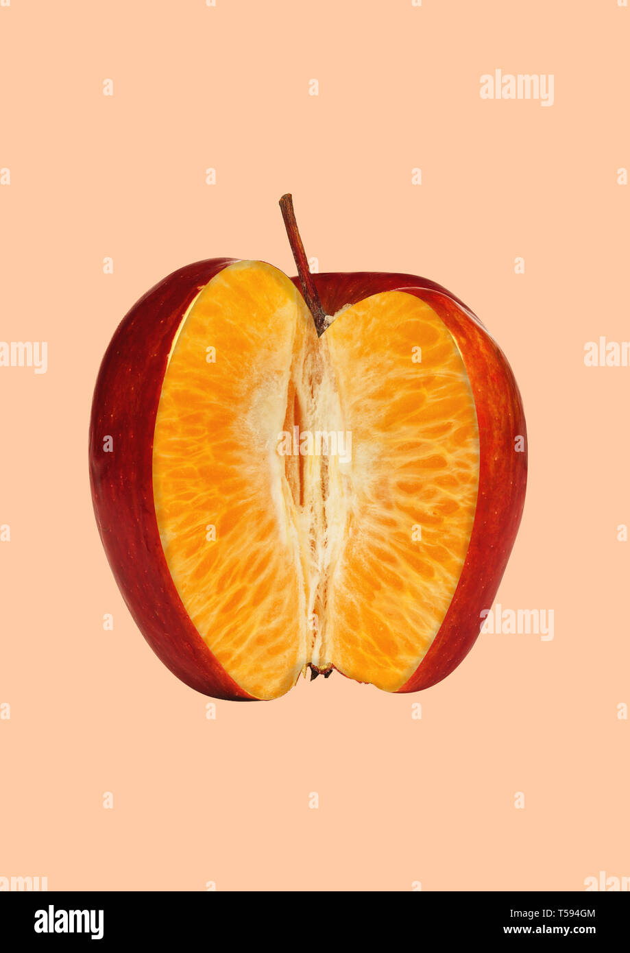 Look deeper to find the truth. A red apple outside and juicy orange inside. Negative space to insert your text. Modern design. Contemporary art collage. Concept of hidden sense of things. Stock Photo