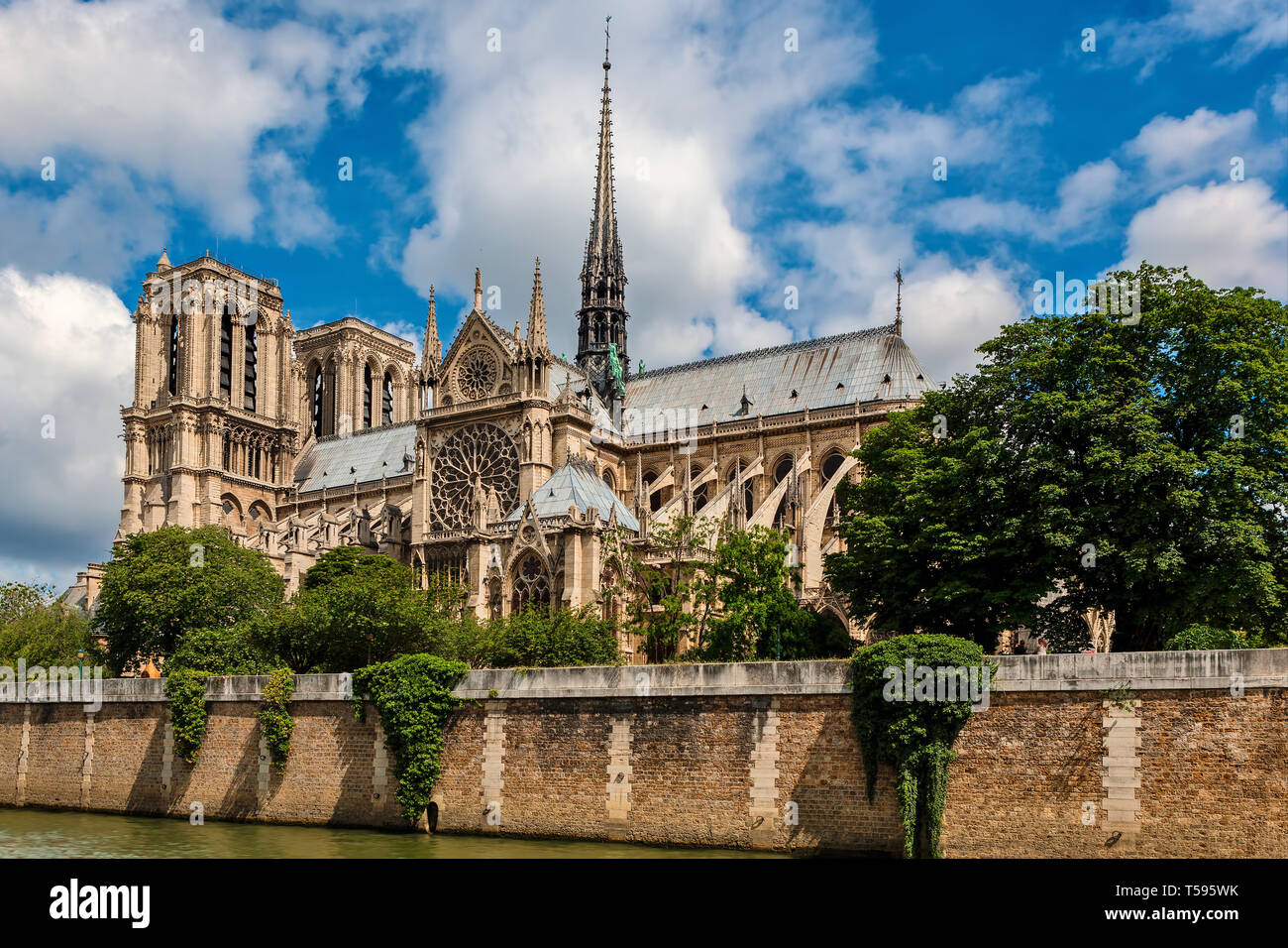 View of famous Notre-Dame cathedral under beautiful sky in Paris, France. Stock Photo