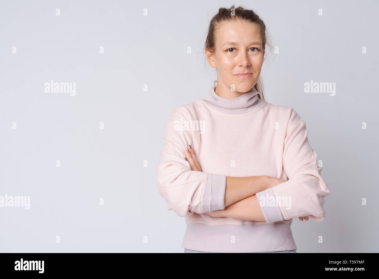 Portrait of young beautiful woman with arms crossed Stock Photo - Alamy