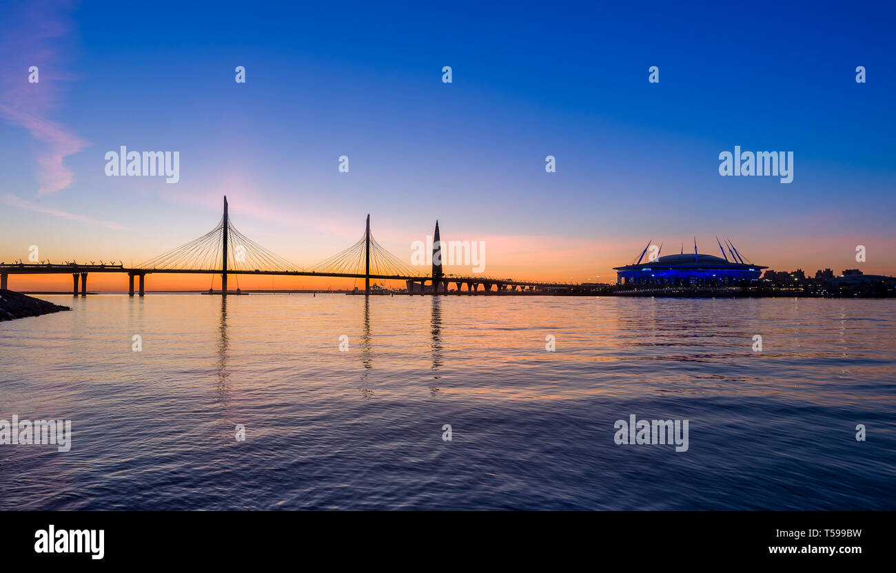 Sunset at Neva river delta with highway bridge. Saint-Petersburg, Russia. Stock Photo