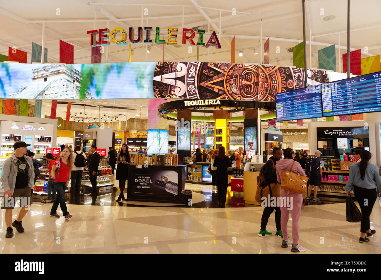 Passengers shopping for tequila in the Tequileria duty free shop Passengers shopping for tequila in the Tequileria duty free shop