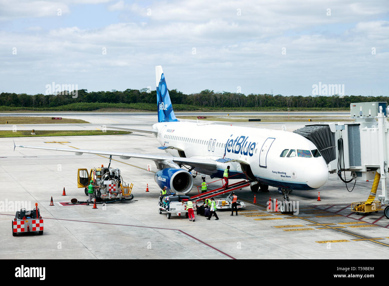 A JetBlue plane on the ground at Cancun Airport, Mexico Stock Photo
