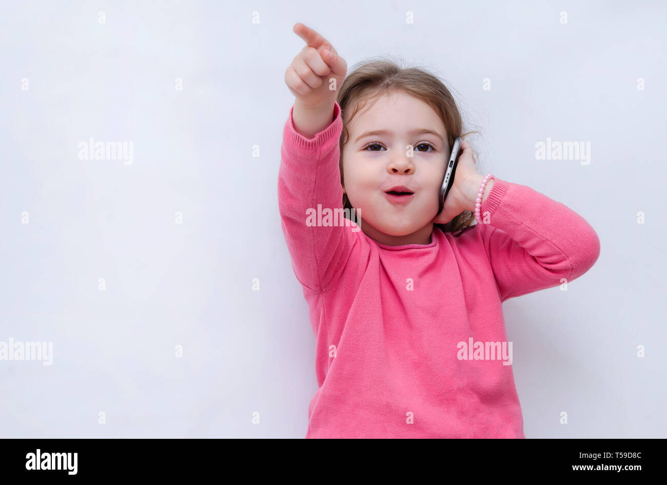 Happy little girl speaking by cell phone Stock Photo