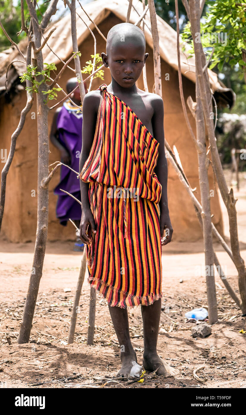 MASAI VILLAGE, KENYA - OCTOBER 11, 2018: Unindentified african child wearing traditional clothes in Masai tribe, Kenya Stock Photo