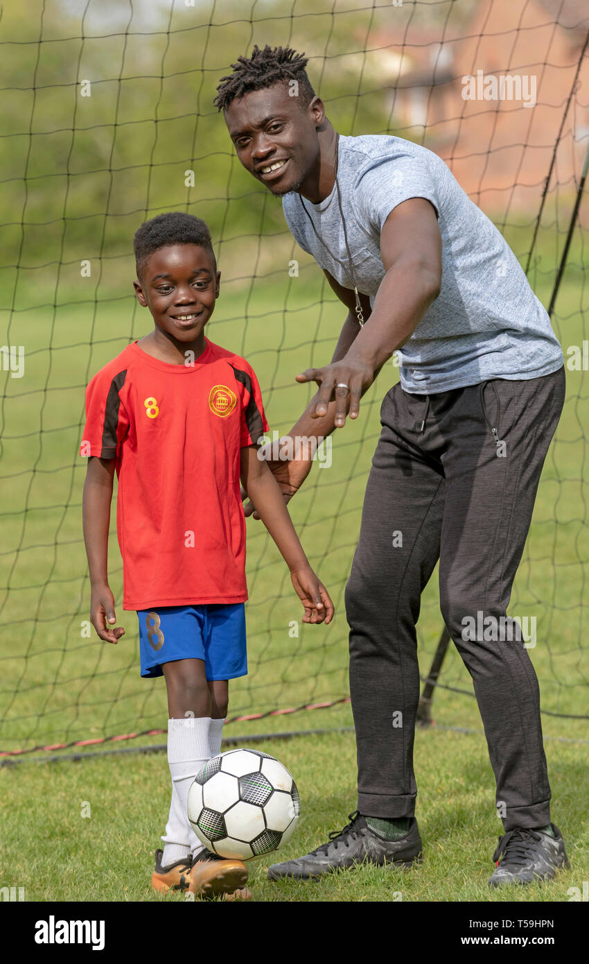 Hampshire, England UK. April 2019. Young soccer player being coached on a football pitch. Stock Photo