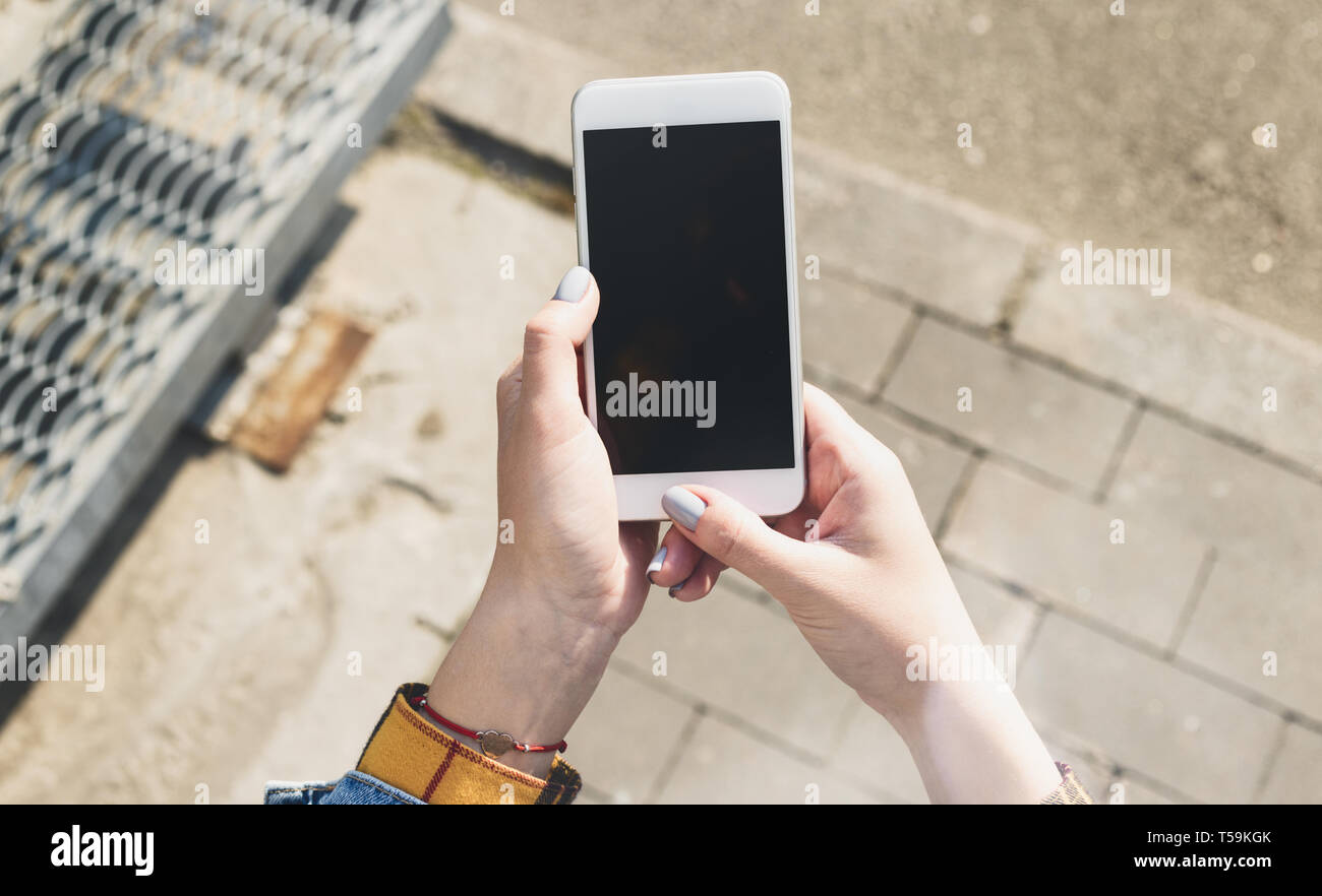 Female hands holding a smartphone with a blank screen Stock Photo - Alamy