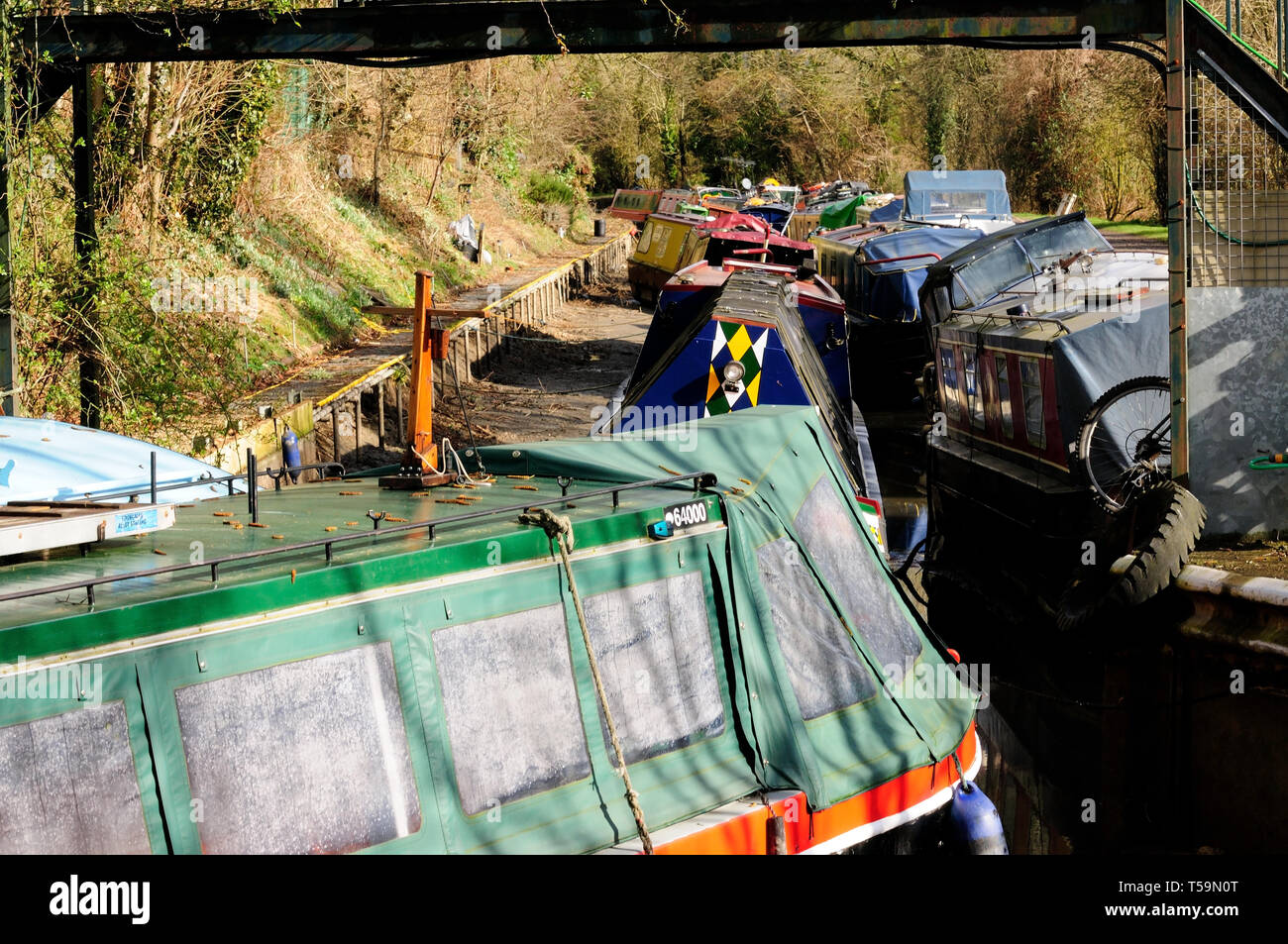 Boats grounded in an empty canal that has been drained for maintenance purposes. Stock Photo