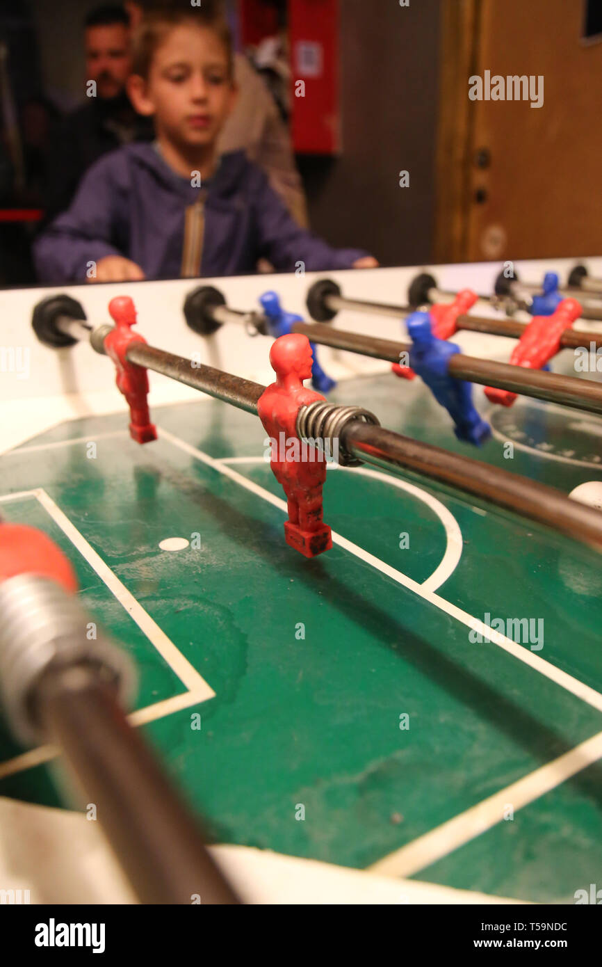 boy in the background play table football in a bar Stock Photo Alamy