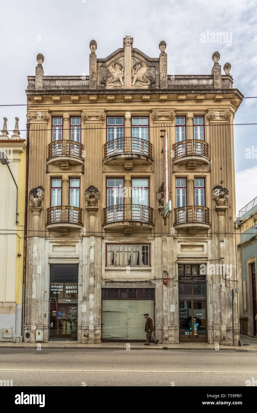 Coimbra / Portugal - 04 04 2019 : View of the exterior facade of a classic building, elderly walking in the street in Coimbra, Portugal Stock Photo