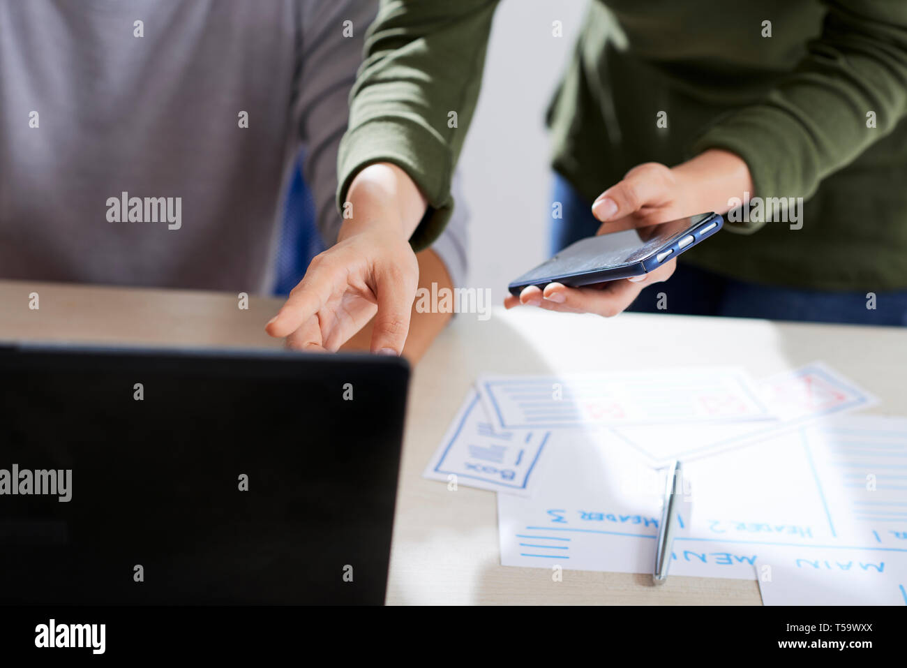 Testing mobile app and discussing mistakes Stock Photo