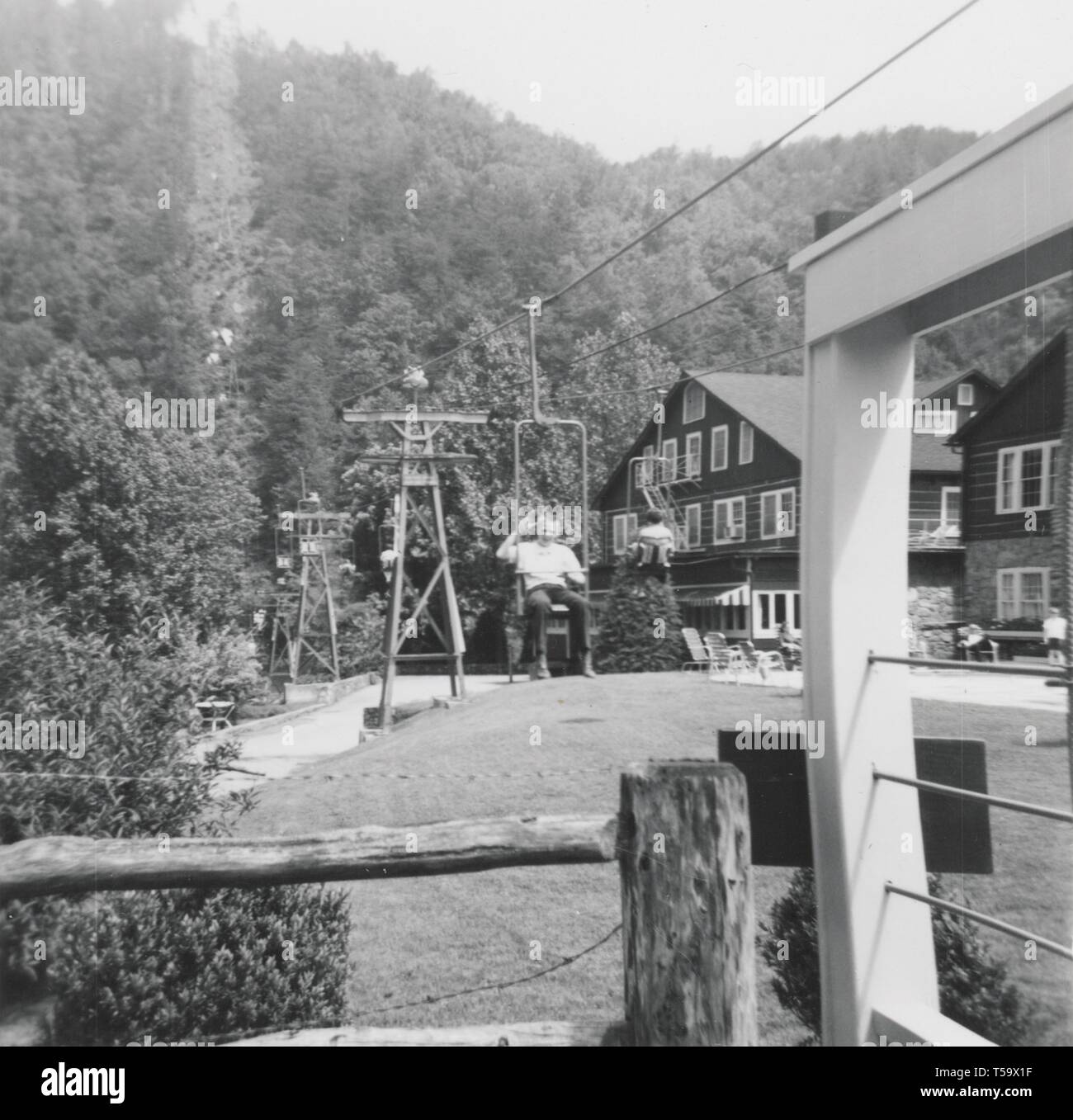 A happy tourist waves as they arrive back in town after riding the ski lift up the mountain at Gatlinburg. Stock Photo