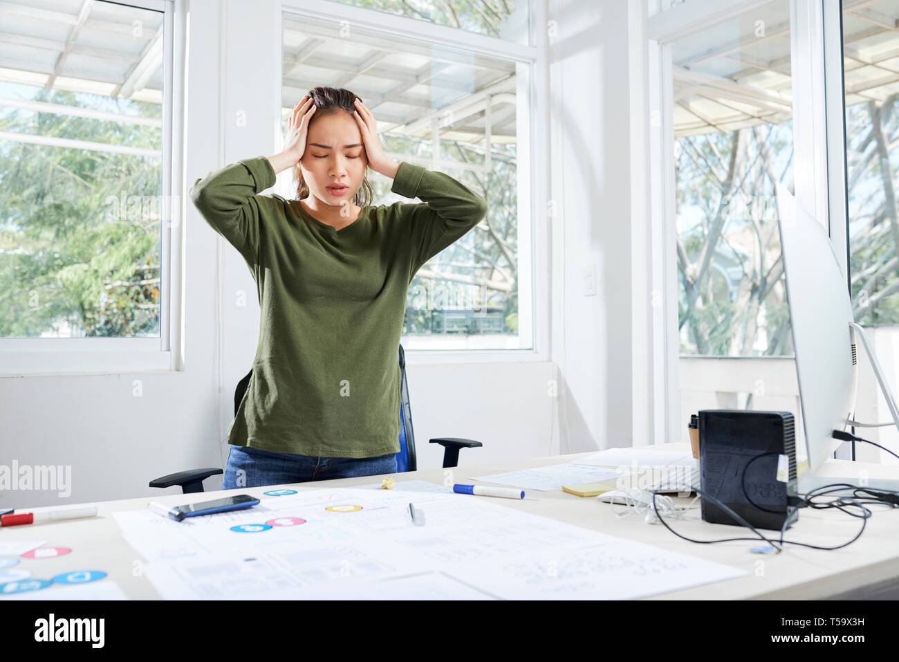 Interface designer having splitting headache Stock Photo