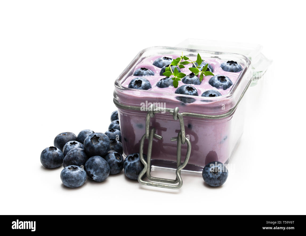 Fresh  blueberries yogurt in glass jar isolated on white Stock Photo