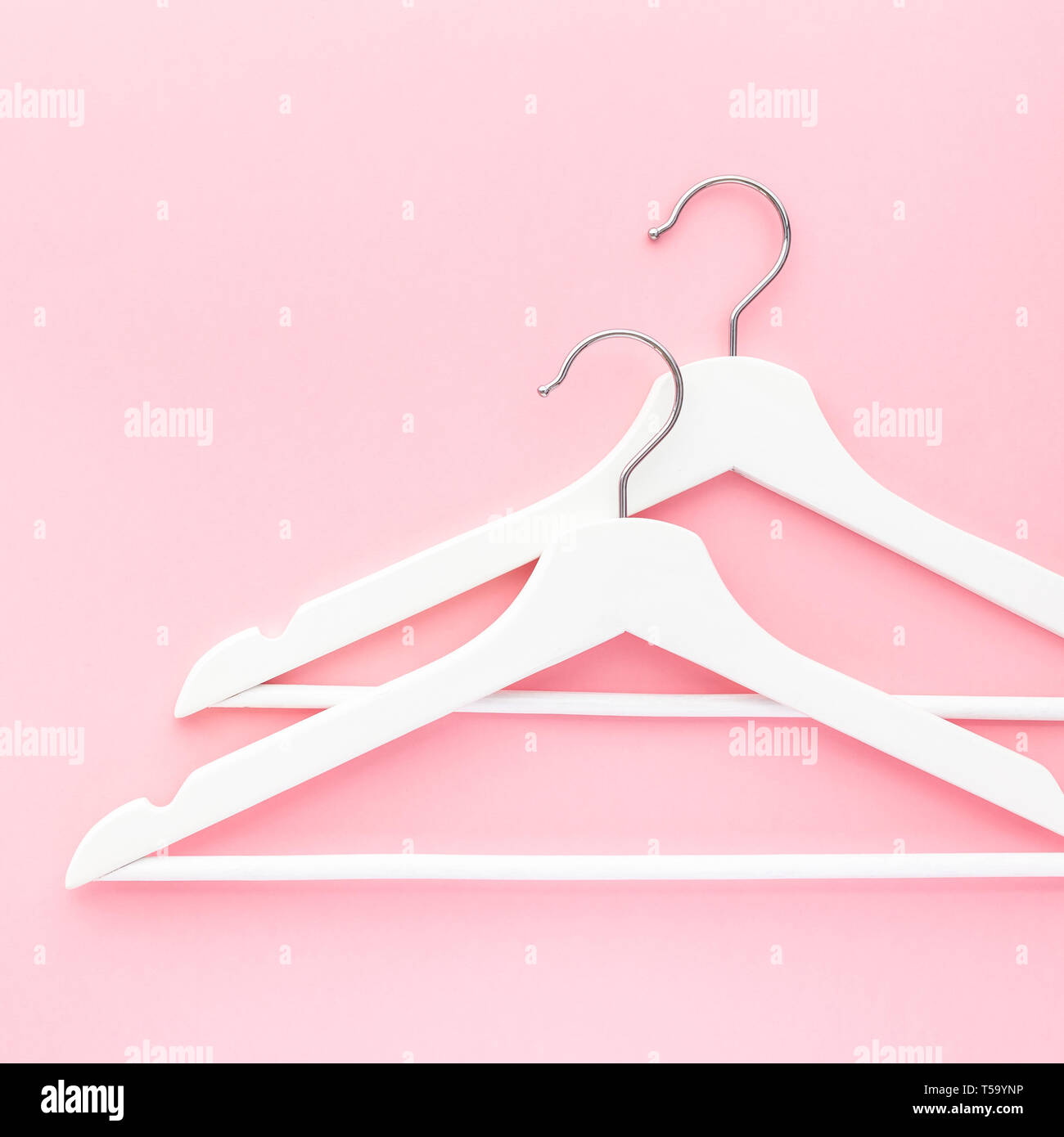 Creative top view flat lay white wooden hangers pastel millennial pink ...