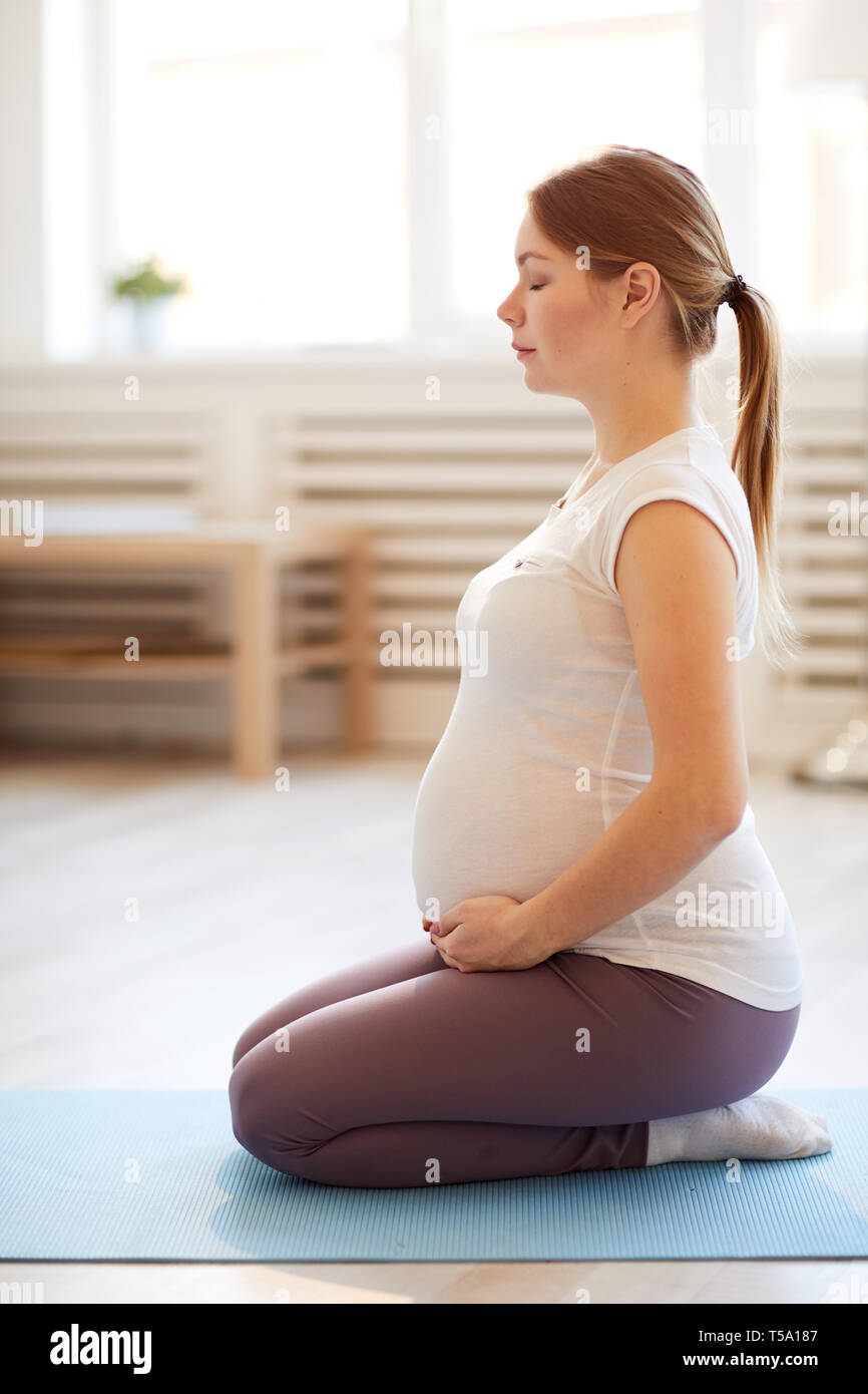 Pregnant Woman doing Breathing Exercises Stock Photo