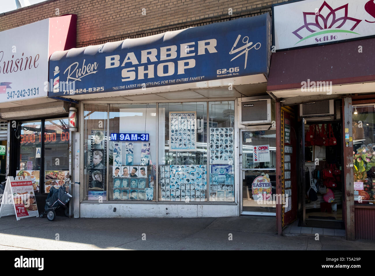 The exterior of RUBEN BARBER SHOP on Roosevelt Avenue under the el in Woodside, Queens, New York City. Stock Photo