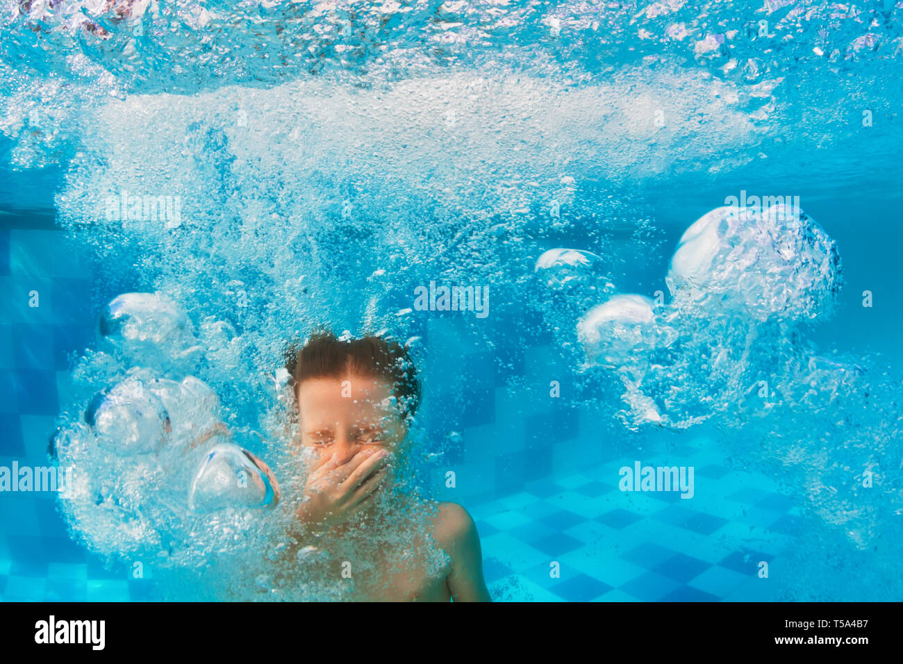 Happy family have fun in swimming pool. Funny child swim, dive in pool